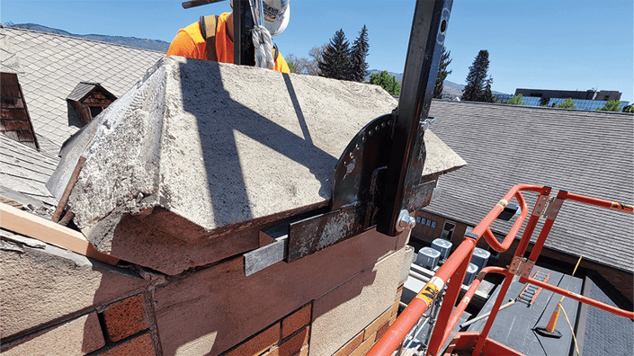 RESTORATION SPECIALIST WORKING ON A CHIMNEY