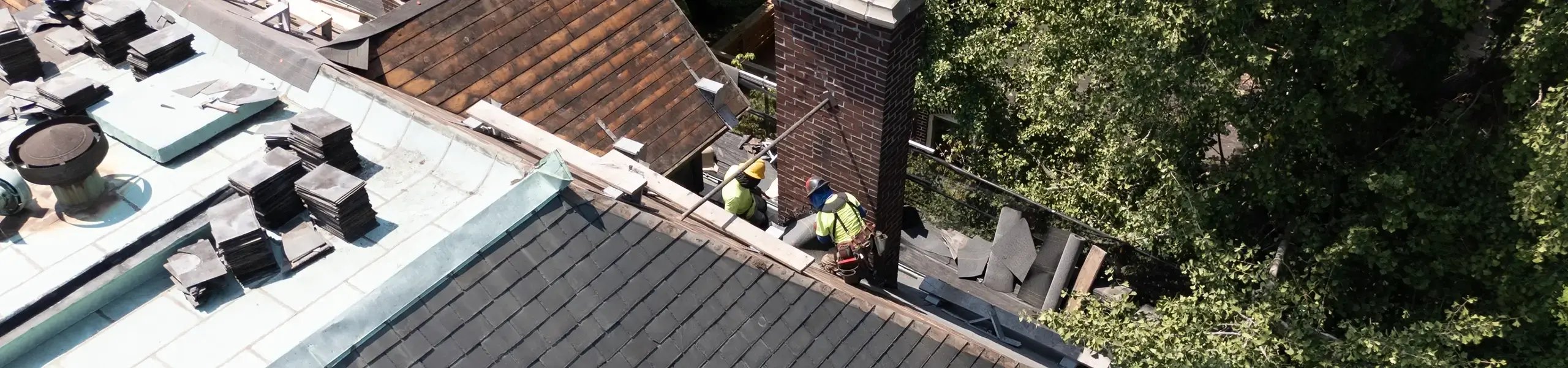 people working to restore a historic roof