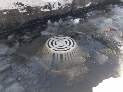 ice damn on a drain for a flat top roof drain