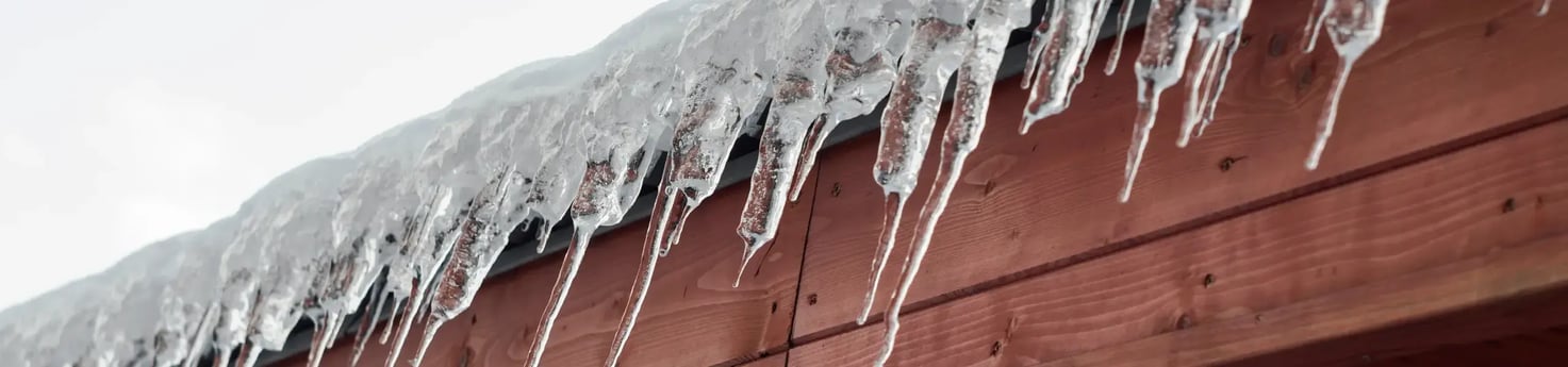 icicles on the gutters of a home