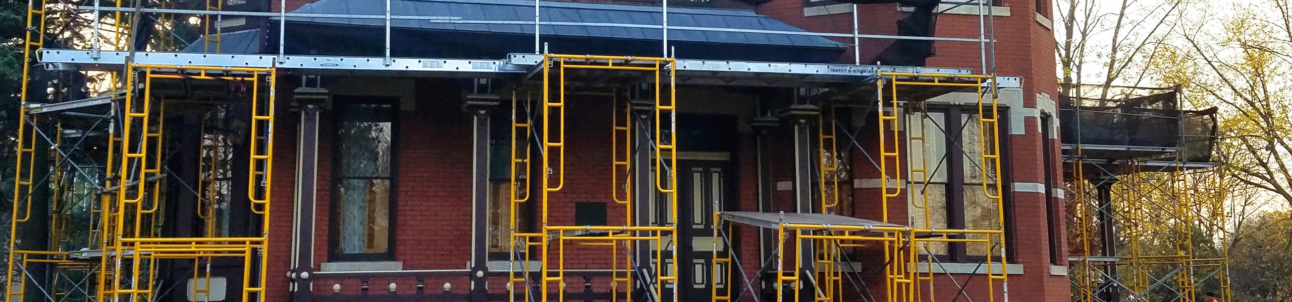 scaffolding around a historic brick home