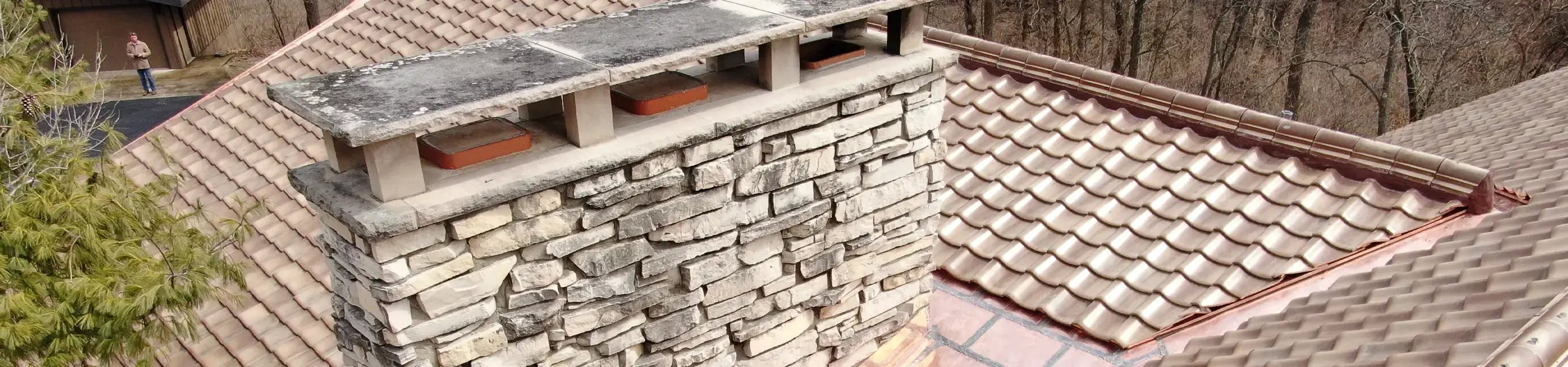 historic tile roof and stone chimney